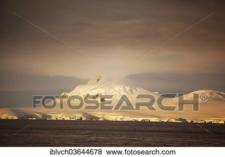 Stock Photo - "Snow-covered rocks, icebergs, in the morning light, Antarctic Peninsula, Antarctica". Fotosearch