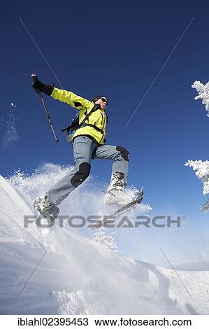 "Snowshoe hiker jumping, Hirschberg, Bavaria, Germany, Europe" View Large Photo Image Stock Image - "Snowshoe hiker jumping, Hirschberg, Bavaria, Germany, Europe". Fotosearch