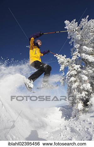 "Snowshoe hiker jumping, Hirschberg, Bavaria, Germany, Europe" View Large Photo Image Stock Photograph - "Snowshoe hiker jumping, Hirschberg, Bavaria, Germany, Europe". Fotosearch
