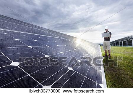 Solar installation technician checking solar panels with his laptop computer View Large Photo Image Stock Image - Solar installation technician checking solar panels with his laptop computer. Fotosearch