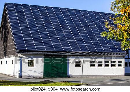 Solar panels on the roof of a barn, on a farm in Niedersorpe, North Rhine-Westphalia, Germany, Europe View Large Photo Image Picture - Solar panels on the roof of a barn, on a farm in Niedersorpe, North Rhine-Westphalia, Germany, Europe. Fotosearch