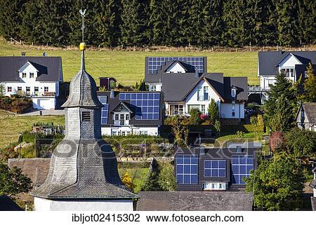 Solar panels on the roofs of residential houses, Oberkirchen, North Rhine-Westphalia, Germany, Europe View Large Photo Image Stock Image - Solar panels on the roofs of residential houses, Oberkirchen, North Rhine-Westphalia, Germany, Europe. Fotosearch