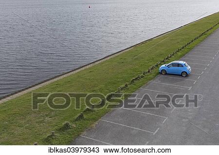 "Solitary car, Fiat 500 parked in an empty parking lot on an inland waterway, Walcheren, Zeeland province, The Netherlands, Europe" View Large Photo Image Stock Image - "Solitary car, Fiat 500 parked in an empty parking lot on an inland waterway, Walcheren, Zeeland province, The Netherlands, Europe". Fotosearch