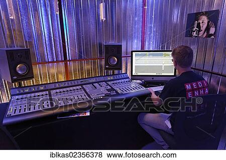 Sound Engineer At The Mixing Desk In A Recording Studio Music