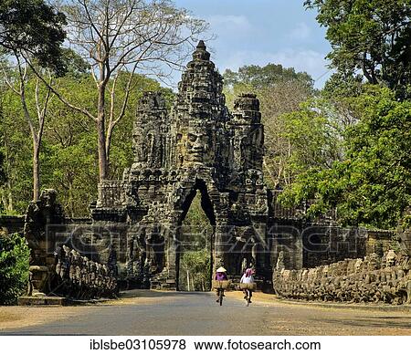"South gate of Angkor Thom, face-tower, cyclists, balustrade of demons on the bridge, Angkor Thom, Siem Reap Province, Cambodia, Asia" View Large Photo Image Stock Photo - "South gate of Angkor Thom, face-tower, cyclists, balustrade of demons on the bridge, Angkor Thom, Siem Reap Province, Cambodia, Asia". Fotosearch