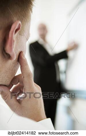 Speaker explaining something on a flip for his audience during a training View Large Photo Image Stock Image - Speaker explaining something on a flip for his audience during a training. Fotosearch