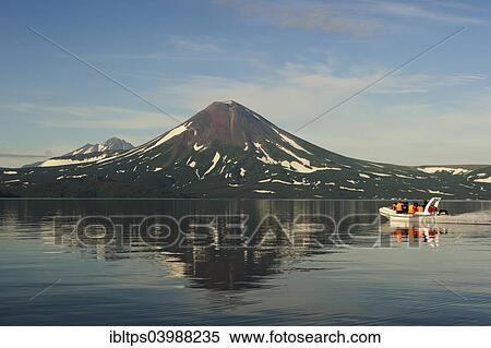 Stock Photography - "Speedboat on Kurile Lake, Ilinskaya volcano at the back, Kurilensee, Kamchatka Peninsula, Russia, Europe". Fotosearch