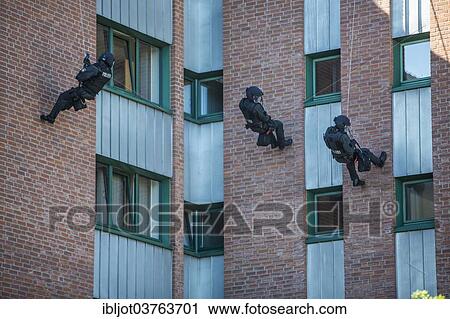 "Spezialeinsatzkommandos, SEK, the special response unit of the German state police forces, abseiling down a wall, exercise of the NRW Police special task forces, North Rhine-Westphalia, Germany, Europe" View Large Photo Image Stock Image - "Spezialeinsatzkommandos, SEK, the special response unit of the German state police forces, abseiling down a wall, exercise of the NRW Police special task forces, North Rhine-Westphalia, Germany, Europe". Fotosearch