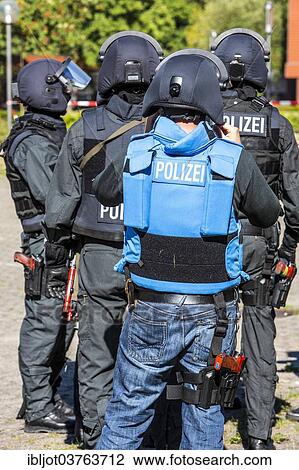"Spezialeinsatzkommandos, SEK, the special response unit of the German state police forces, with weapons not capable of shooting, marked red, during an exercise of the NRW Police special task forces, North Rhine-Westphalia, Germany, Europe" View Large Photo Image Stock Image - "Spezialeinsatzkommandos, SEK, the special response unit of the German state police forces, with weapons not capable of shooting, marked red, during an exercise of the NRW Police special task forces, North Rhine-Westphalia, Germany, Europe". Fotosearch