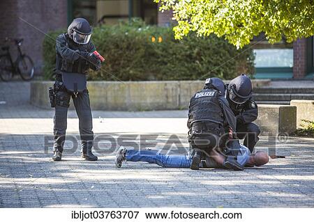 "Spezialeinsatzkommandos, SEK, the special response unit of the German state police forces, using weapons not capable of shooting, marked red, during an exercise of the NRW Police special task forces, North Rhine-Westphalia, Germany, Europe" View Large Photo Image Stock Photo - "Spezialeinsatzkommandos, SEK, the special response unit of the German state police forces, using weapons not capable of shooting, marked red, during an exercise of the NRW Police special task forces, North Rhine-Westphalia, Germany, Europe". Fotosearch