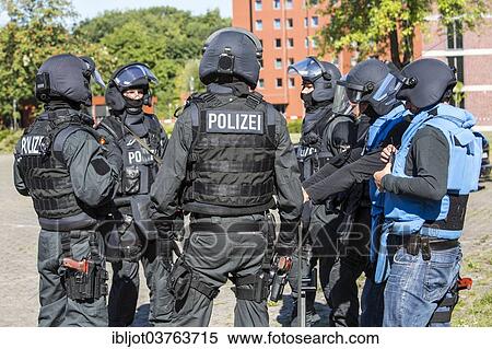 "Spezialeinsatzkommandos, SEK, the special response unit of the German state police forces, with weapons not capable of shooting, marked red, during an exercise of the NRW Police special task forces, North Rhine-Westphalia, Germany, Europe" View Large Photo Image Stock Photography - "Spezialeinsatzkommandos, SEK, the special response unit of the German state police forces, with weapons not capable of shooting, marked red, during an exercise of the NRW Police special task forces, North Rhine-Westphalia, Germany, Europe". Fotosearch