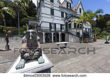 Stock Photo - "Sphinx sculpture in front of the palace, Jardim Botanico da Madeira or Botanical Garden, on the grounds of the farm of the Reid hotelier family, Jose Bernardo foundation, Terreiro da Luta, Funchal, Madeira, Portugal, Europe". Fotosearch