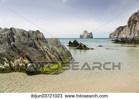 Stock Image - "Spiaggia di Masua bay with the Pan di Zuccherof â€‹â€‹rock island in the sea, Masua, Iglesiente, Sardinia, Italy, Europe". Fotosearch
