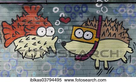 Stock Photography - "Spiny fish figure kissing a hedgehog figure wearing goggles, mural, North Rhine-Westphalia, Germany, Europe". Fotosearch