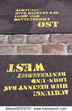 "Sprayed words """"Achtung! Hier beginnt das Lohn- und Rentengebiet Ost, West"""" or """"Warning! Here begins the wage and pension area east, west"""", former Berlin Wall, Potsdamer Platz, Berlin, Germany, Europe" View Large Photo Image Stock Photo - "Sprayed words """"Achtung! Hier beginnt das Lohn- und Rentengebiet Ost, West"""" or """"Warning! Here begins the wage and pension area east, west"""", former Berlin Wall, Potsdamer Platz, Berlin, Germany, Europe". Fotosearch