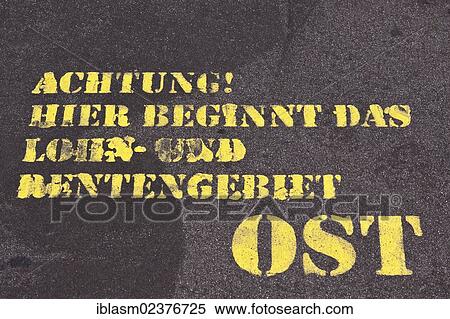 Stock Photography - "Sprayed words """"Achtung! Hier beginnt das Lohn- und Rentengebiet Ost"""" or """"Warning! Here begins the wage and pension area east"""", former Berlin Wall, Potsdamer Platz, Berlin, Germany, Europe". Fotosearch