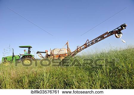Stock Image - "Spraying of pesticides on a field in a Mennonite community, Bergthal, Caaguazu Department, Paraguay, South America". Fotosearch