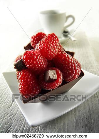 Square chocolate cake filled with chocolate truffle and topped with fresh raspberries View Large Photo Image Stock Photo - Square chocolate cake filled with chocolate truffle and topped with fresh raspberries. Fotosearch