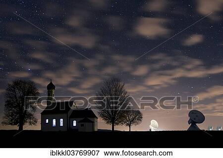 "St. Johann Chapel and the satellite earth station in front of the night sky, Raisting, Bavaria, Germany, Europe" View Large Photo Image Stock Photo - "St. Johann Chapel and the satellite earth station in front of the night sky, Raisting, Bavaria, Germany, Europe". Fotosearch