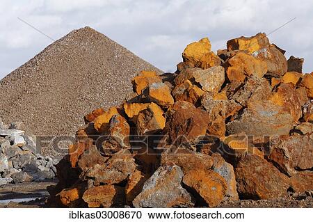 Stock Image - "Stack of rusty ferruginous rocks waiting to be recycled, Krefeld, North Rhine-Westphalia, Germany, Europe". Fotosearch