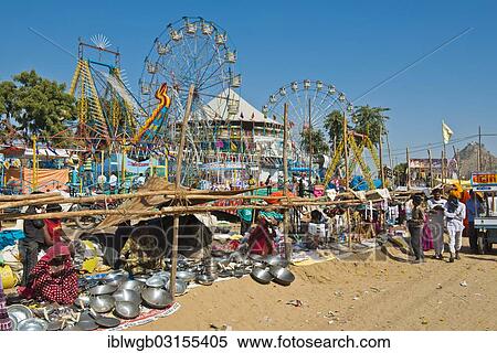 "Stalls selling pots and Chapati pans, carnival with Ferris wheels at back, Pushkar Camel Fair, Pushkar, Rajasthan, India, Asia" View Large Photo Image Stock Photography - "Stalls selling pots and Chapati pans, carnival with Ferris wheels at back, Pushkar Camel Fair, Pushkar, Rajasthan, India, Asia". Fotosearch