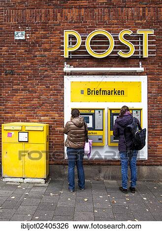 Stock Photograph - "Stamp machines, mail box of the German Mail at a post office, Domplatz, Muenster, North Rhine-Westphalia, Germany, Europe". Fotosearch