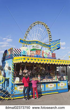 "Stand selling candy and a ferris wheel at back, Cannstatter Wasen spring festival, Stuttgart Beer Festival, Stuttgart, Baden-Wuerttemberg, Germany, Europe" View Large Photo Image Stock Image - "Stand selling candy and a ferris wheel at back, Cannstatter Wasen spring festival, Stuttgart Beer Festival, Stuttgart, Baden-Wuerttemberg, Germany, Europe". Fotosearch