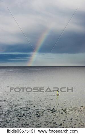 "Stand up paddler with rainbow over the sea, L'Escala, Costa Brava, Catalonia, Spain, Europe" View Large Photo Image Stock Image - "Stand up paddler with rainbow over the sea, L'Escala, Costa Brava, Catalonia, Spain, Europe". Fotosearch