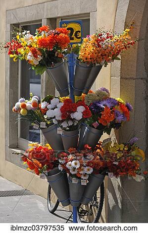 "Stand with artificial flowers outside a shop, Bavaria, Germany, Europe" View Large Photo Image Stock Photography - "Stand with artificial flowers outside a shop, Bavaria, Germany, Europe". Fotosearch