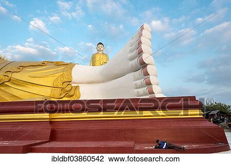 "Standing Buddha behind the reclining Buddha, statues, man lying in front of the reclinging Buddha, Lay Kyun Sakkya, Maha Bodhi Ta Htaung, Monywa, Sagaing Region, Myanmar, Asia" View Large Photo Image Stock Image - "Standing Buddha behind the reclining Buddha, statues, man lying in front of the reclinging Buddha, Lay Kyun Sakkya, Maha Bodhi Ta Htaung, Monywa, Sagaing Region, Myanmar, Asia". Fotosearch