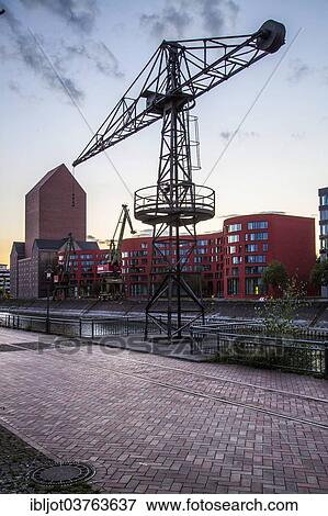 "State Archives of North Rhine-Westphalia, converted archive tower in the former RWSG storage building, next to the wave-shaped new building, Innenhafen, Duisburg, Ruhr district, North Rhine-Westphalia, Germany, Europe" View Large Photo Image Stock Photo - "State Archives of North Rhine-Westphalia, converted archive tower in the former RWSG storage building, next to the wave-shaped new building, Innenhafen, Duisburg, Ruhr district, North Rhine-Westphalia, Germany, Europe". Fotosearch