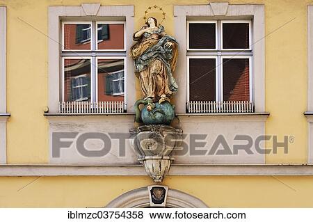 "Statue, depicting the Immaculate Conception of Mary, between two windows of the Adler pharmacy, Dinkelsbuhl, Middle Franconia, Bavaria, Germany, Europe" View Large Photo Image Stock Photo - "Statue, depicting the Immaculate Conception of Mary, between two windows of the Adler pharmacy, Dinkelsbuhl, Middle Franconia, Bavaria, Germany, Europe". Fotosearch