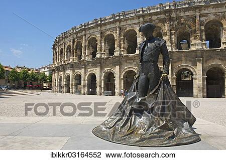Stock Image - "Statue of a bullfighter in front of the Roman amphitheatre, Nimes, Region Languedoc-Roussillon, France, Europe". Fotosearch