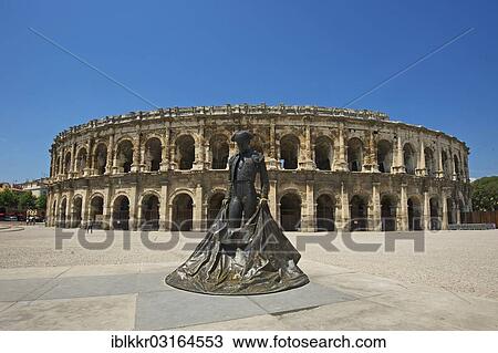 Stock Image - "Statue of a bullfighter in front of the Roman amphitheatre, Nimes, Region Languedoc-Roussillon, France, Europe". Fotosearch