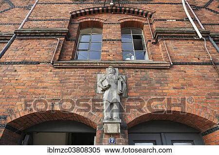 Stock Photography - "Statue of a longshoreman, circa 1883, above the entrance of the Speicherstadt warehouse district, Hamburg, Germany, Europe". Fotosearch