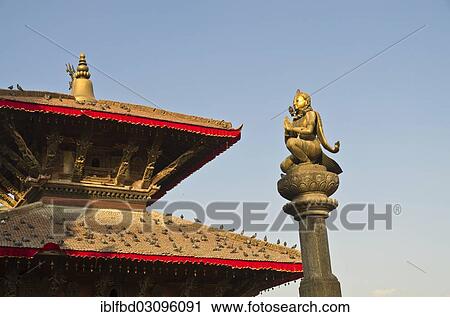 Stock Image - "Statue of Garuda on Patan Durbar Square, the roof of a temple at the back, Patan, Lalitpur District, Bagmati Zone, Nepal, Asia". Fotosearch