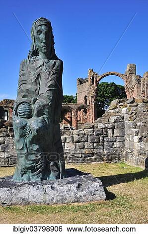 Stock Photograph - "Statue of Saint Cuthbert of Lindisfarne, ruins of the Benedictine monastery of Lindisfarne, Lindisfarne, Northumbria, England, United Kingdom, Europe". Fotosearch