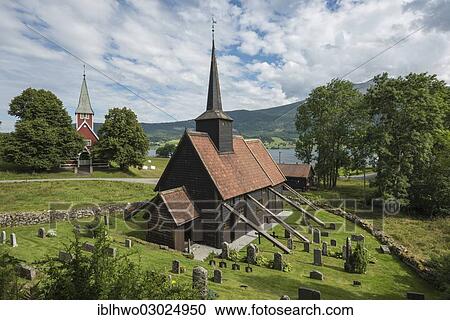 "Stave Church with external supports in the fjord landscape, with grave stones in the front and another church at the rear, from 1907, Roedven, Gemeinde Rauma, Eresfjorden, More og Romsdal, Western Norway, Norway, Europe" View Large Photo Image Stock Image - "Stave Church with external supports in the fjord landscape, with grave stones in the front and another church at the rear, from 1907, Roedven, Gemeinde Rauma, Eresfjorden, More og Romsdal, Western Norway, Norway, Europe". Fotosearch
