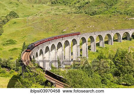 Stock Photo - "Steam train on Glenfinnan Viaduct, arched railway bridge on West Highland Line, Lochaber, Scotland, United Kingdom, Europe". Fotosearch