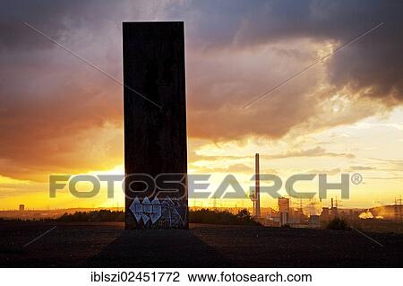 Stock Image - "Steel slab on Schurenbachhalde, a former spoil tip, in Essen with a view towards the and the Prosper II coal mine and the Prosper coking plant in Bottrop, North Rhine-Westphalia, Germany, Europe, PublicGround, Europe". Fotosearch