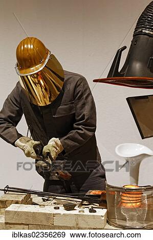 "Steelworker wearing a gold plated protective mask, steel recycling demonstration, IdeenPark 2012, a technology and education summit conference for young people, Essen, Ruhr area, North Rhine-Westphalia, Germany, Europe" View Large Photo Image Stock Photo - "Steelworker wearing a gold plated protective mask, steel recycling demonstration, IdeenPark 2012, a technology and education summit conference for young people, Essen, Ruhr area, North Rhine-Westphalia, Germany, Europe". Fotosearch