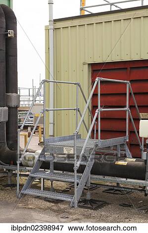 "Steps giving access over roof top industrial plant pipework, Southampton, Hampshire, England, United Kingdom, Europe" View Large Photo Image Stock Photo - "Steps giving access over roof top industrial plant pipework, Southampton, Hampshire, England, United Kingdom, Europe". Fotosearch
