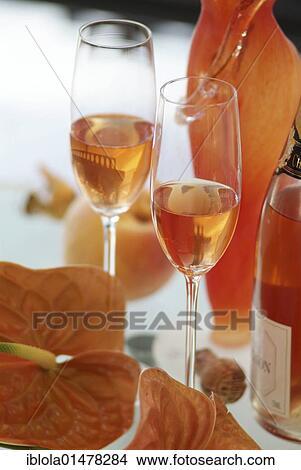 Still life with 2 glasses of rose champagne and a champagne bottle in a stylish ambience View Large Photo Image Picture - Still life with 2 glasses of rose champagne and a champagne bottle in a stylish ambience. Fotosearch