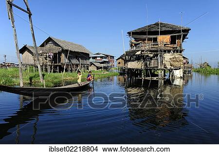 "Stilt houses and two children in a boat on Lake Inle, Burma also known as Myanmar, Southeast Asia, Asia" View Large Photo Image Picture - "Stilt houses and two children in a boat on Lake Inle, Burma also known as Myanmar, Southeast Asia, Asia". Fotosearch