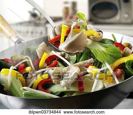 Picture - Stir-fry vegetables in a wok. Fotosearch