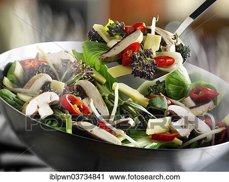 Stock Image - Stir-fry vegetables in a wok. Fotosearch