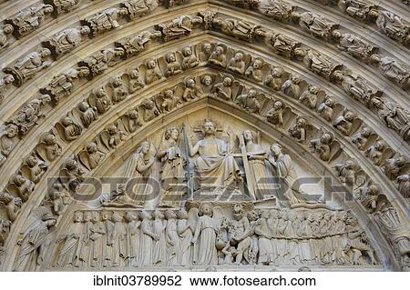 Stock Image - "Stone carvings and sculptures over the main portal, Notre Dame de Paris cathedral, Paris, Ile-de-France, France, Europe". Fotosearch