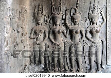Stock Image - "Stone carvings of divine dancers, Apsaras in the temple complex of Angkor Wat, Siem Reap, Cambodia, Asia". Fotosearch