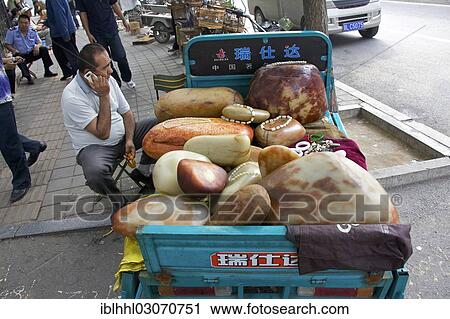 Stock Image - "Stone dealer at the market of Tianjiao, Beijing, China, People's Republic of China, Asia". Fotosearch