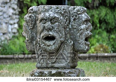 Stock Photo - "Stone mask with four heads at the grotto of the water source, Fontana del Diluvio, flood fountain, garden of Villa Lante, Bagnaia, Lazio, Italy, Europe". Fotosearch